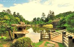 Japanese garden landscape - lantern and teahouse in Hikone Genkyu-en